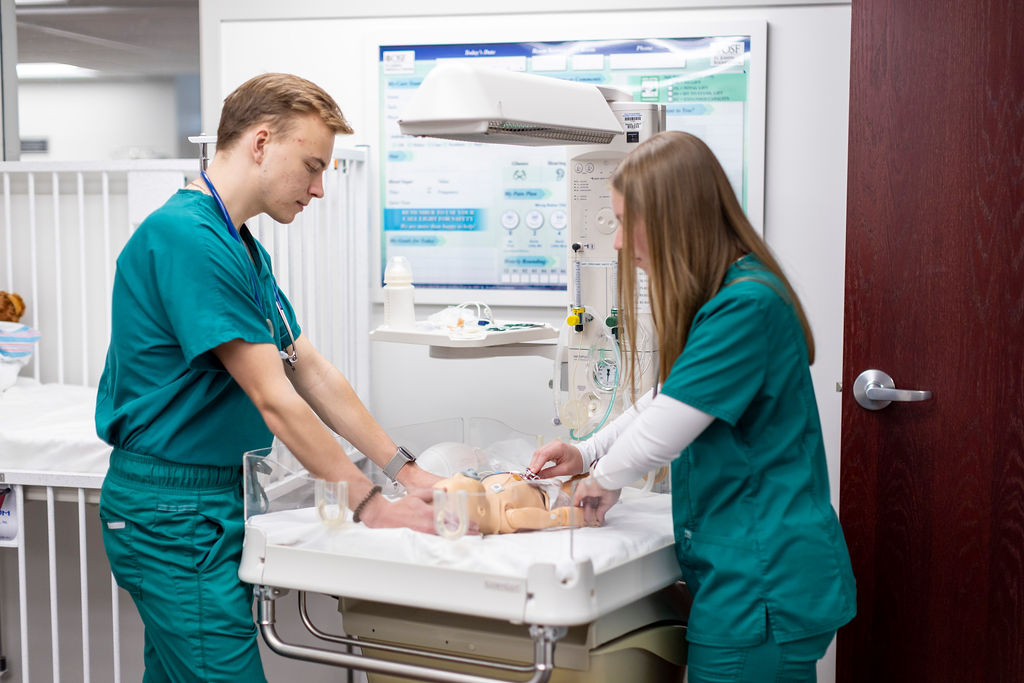 Illinois Wesleyan nursing students practicing patient care in the simulation lab