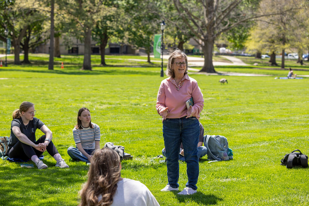 Illinois Wesleyan students gathered on the lawn outside a campus academic building
