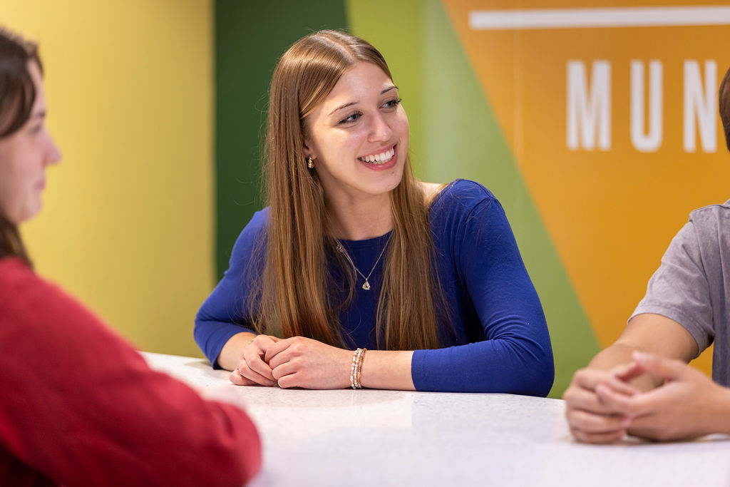 Illinois Wesleyan students talking together in a campus commons