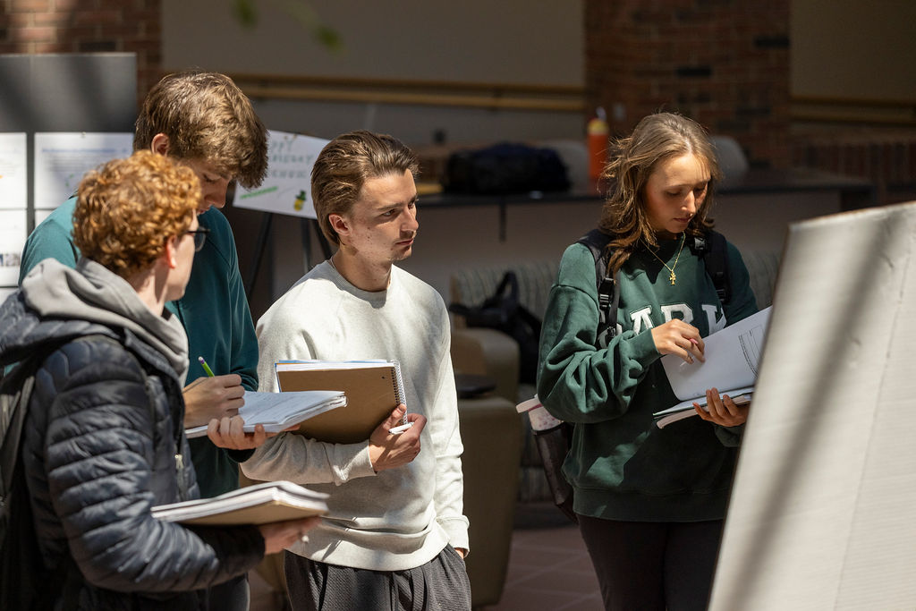 Illinois Wesleyan students presenting their research at a poster session